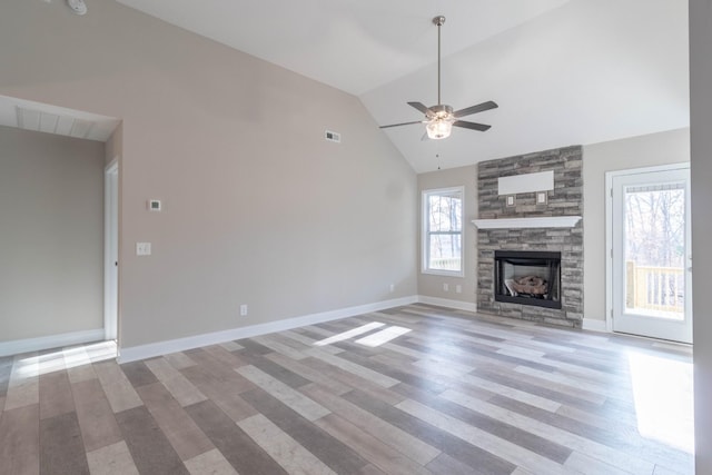 unfurnished living room featuring light wood-type flooring, a fireplace, and a wealth of natural light