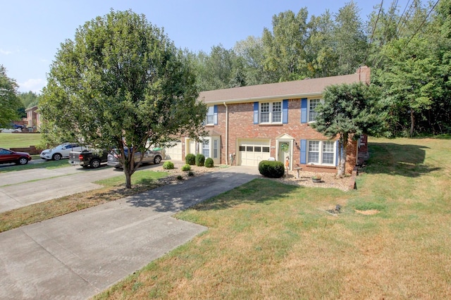 view of front of home with a garage and a front lawn