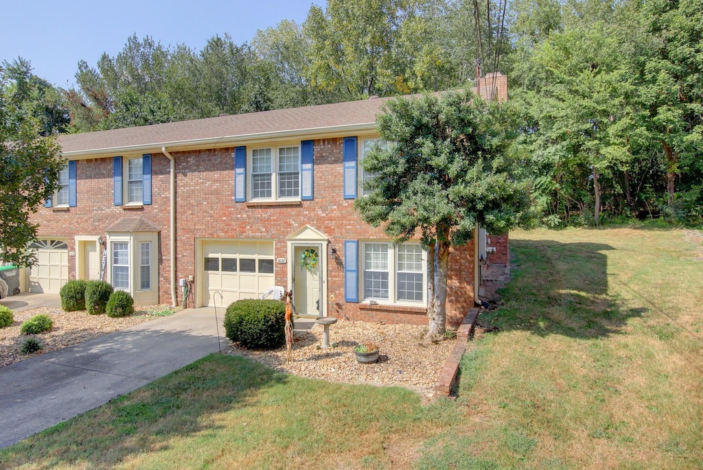 view of front of house featuring a garage and a front lawn