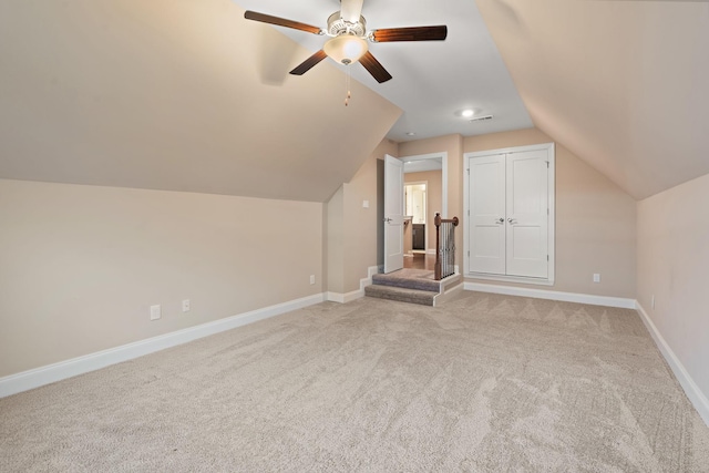 additional living space with ceiling fan, light carpet, and vaulted ceiling