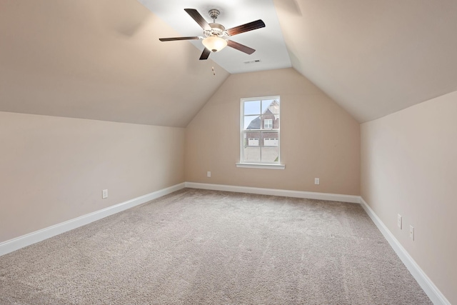 additional living space with carpet flooring, ceiling fan, and lofted ceiling