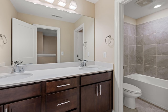 full bathroom with tile patterned floors, vanity, toilet, and tiled shower / bath combo