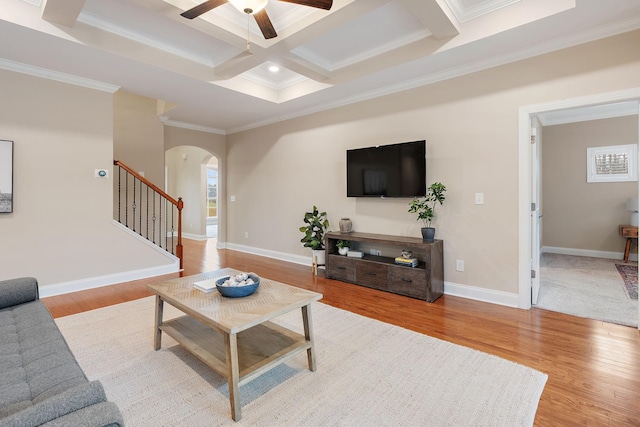 living room with beam ceiling, crown molding, light hardwood / wood-style floors, and coffered ceiling