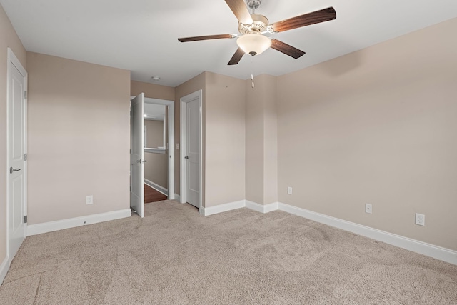 unfurnished bedroom with light colored carpet and ceiling fan