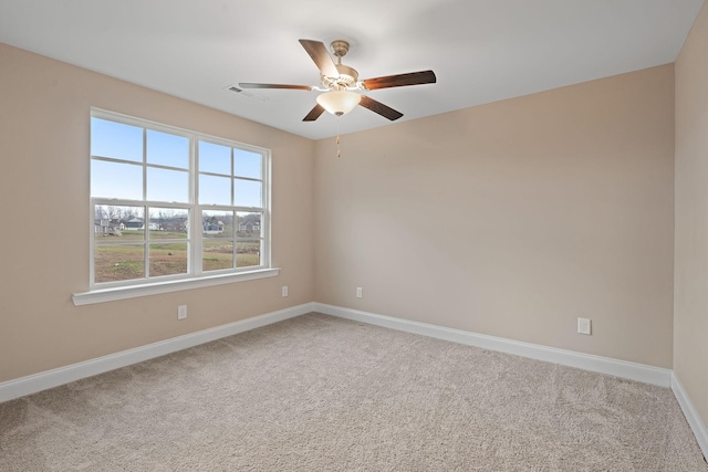 carpeted spare room with ceiling fan