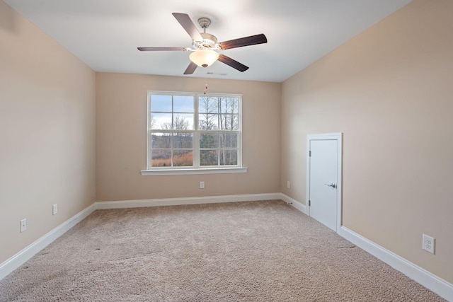 empty room featuring carpet flooring and ceiling fan