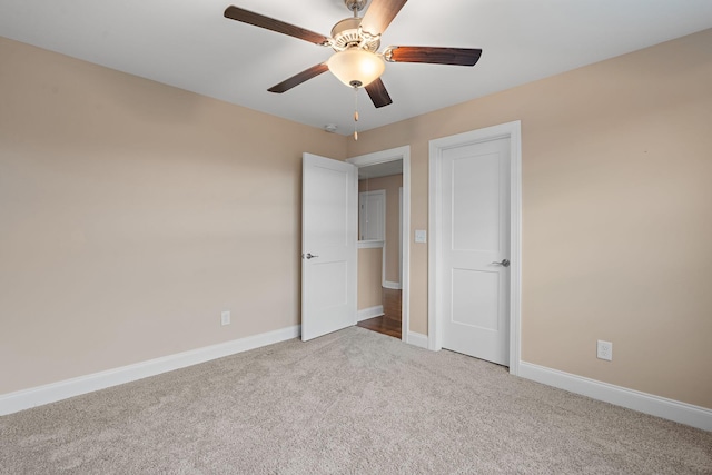 unfurnished bedroom featuring light carpet and ceiling fan