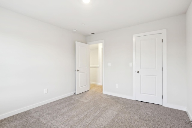 unfurnished bedroom featuring baseboards and carpet floors