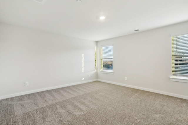 empty room with baseboards and carpet floors