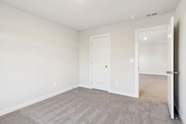 unfurnished bedroom featuring visible vents, carpet floors, and baseboards