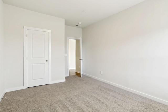 unfurnished bedroom featuring visible vents, baseboards, and carpet