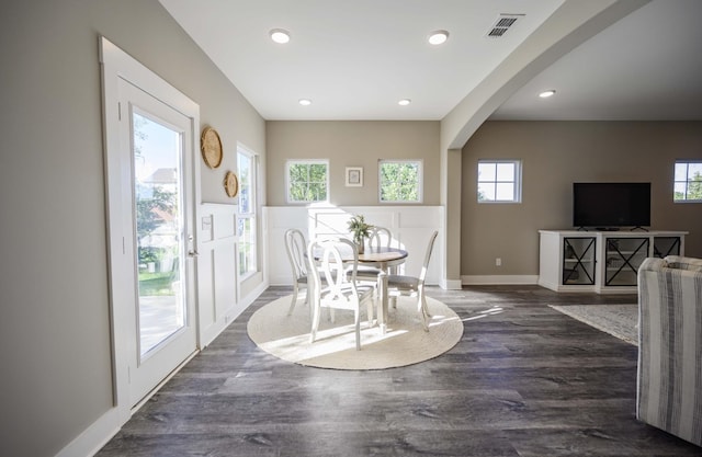 dining area featuring plenty of natural light and dark hardwood / wood-style flooring