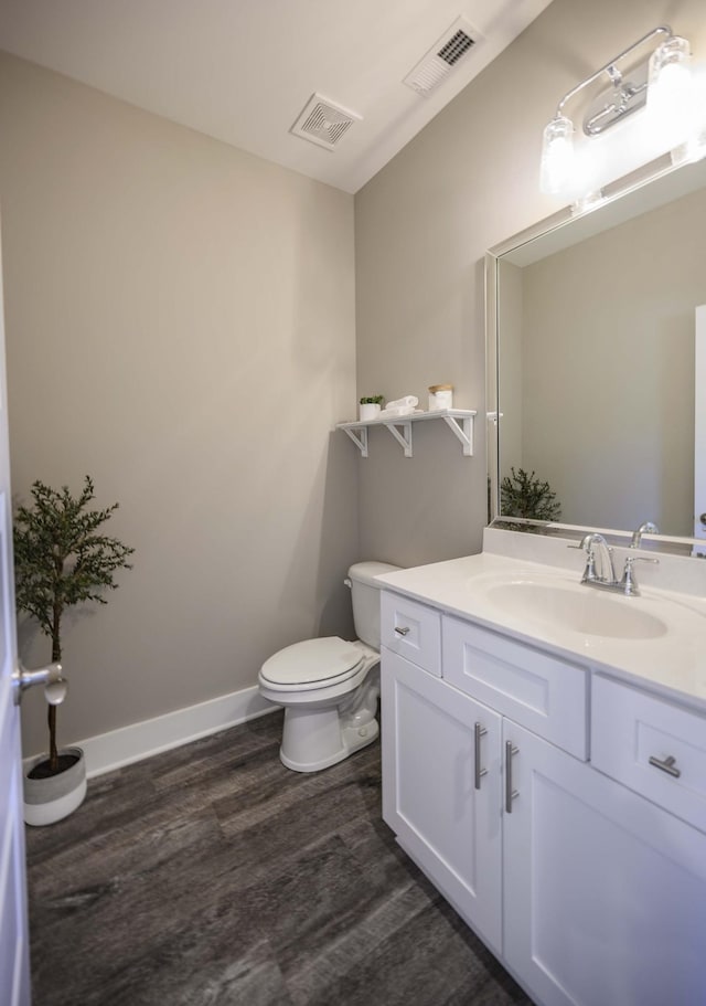 bathroom with vanity, hardwood / wood-style flooring, and toilet