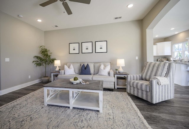 living room featuring dark hardwood / wood-style flooring and ceiling fan