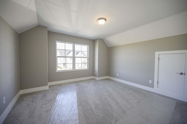 bonus room featuring light colored carpet and lofted ceiling