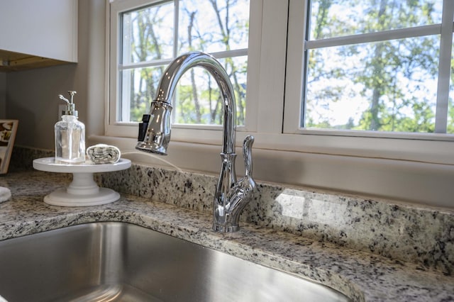 interior details with light stone countertops and sink