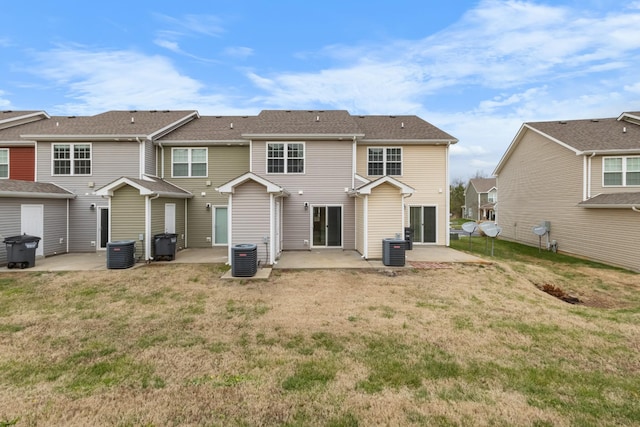 rear view of house featuring a patio, cooling unit, and a lawn