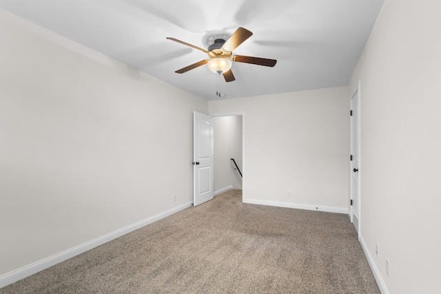 spare room with ceiling fan and carpet floors