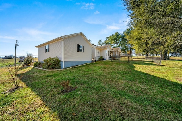 view of side of home with a lawn