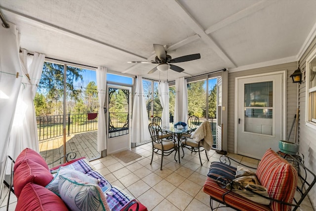 sunroom featuring ceiling fan