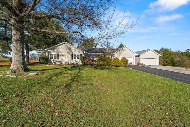 single story home with a front yard and a garage