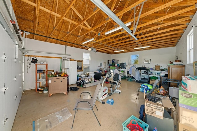 garage featuring white refrigerator with ice dispenser