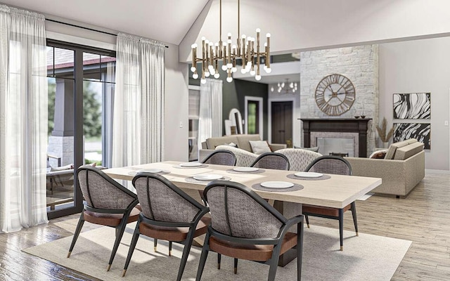 dining area featuring a stone fireplace, a chandelier, plenty of natural light, and light hardwood / wood-style floors