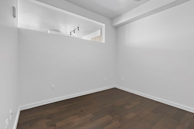 unfurnished room with dark hardwood / wood-style flooring