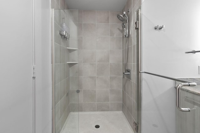 bathroom featuring a shower with shower door