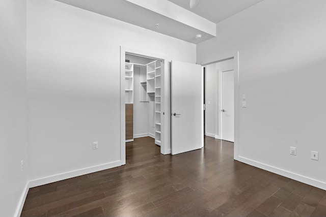 unfurnished room with dark hardwood / wood-style flooring