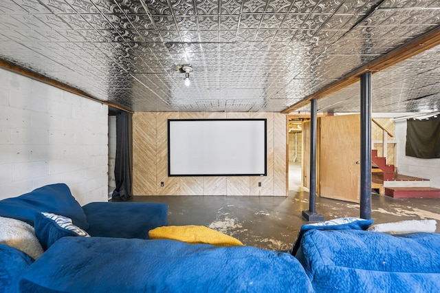 cinema room featuring concrete floors