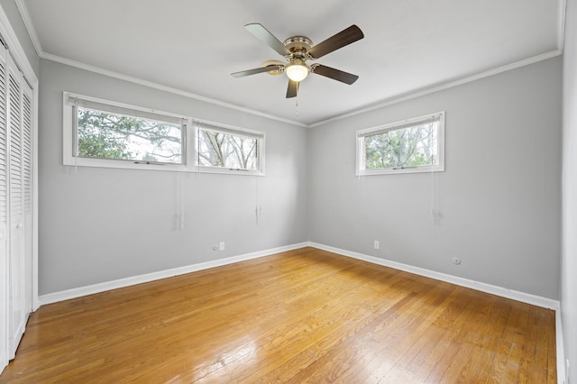 unfurnished room featuring ceiling fan, light hardwood / wood-style flooring, and ornamental molding