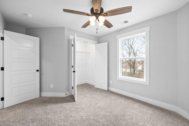 unfurnished bedroom with ceiling fan, a closet, and carpet floors