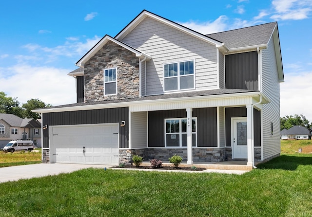 view of front facade with a porch, a garage, and a front yard