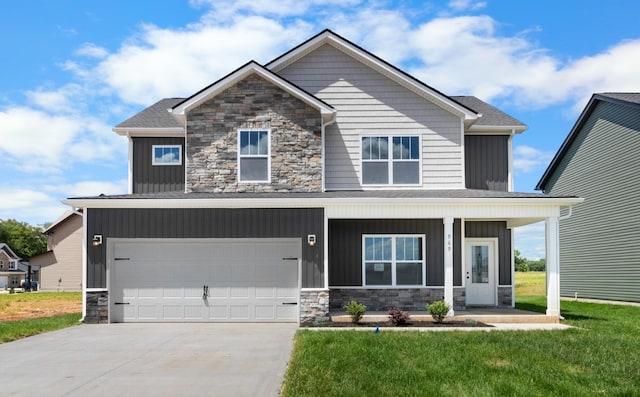 view of front of home featuring a front yard and a garage