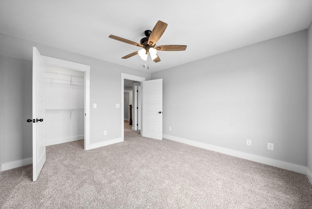 unfurnished bedroom featuring ceiling fan, a closet, and light colored carpet