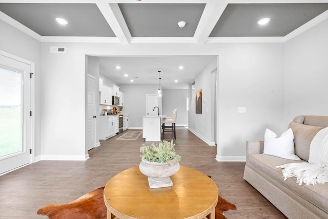 living room with beam ceiling, crown molding, coffered ceiling, and hardwood / wood-style flooring