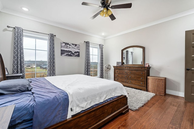 bedroom with dark hardwood / wood-style flooring, ceiling fan, and ornamental molding