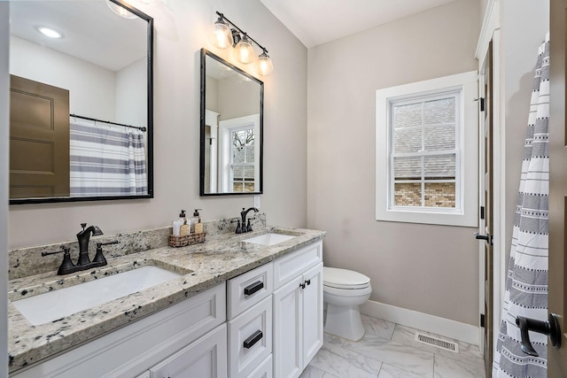 bathroom featuring vanity and toilet