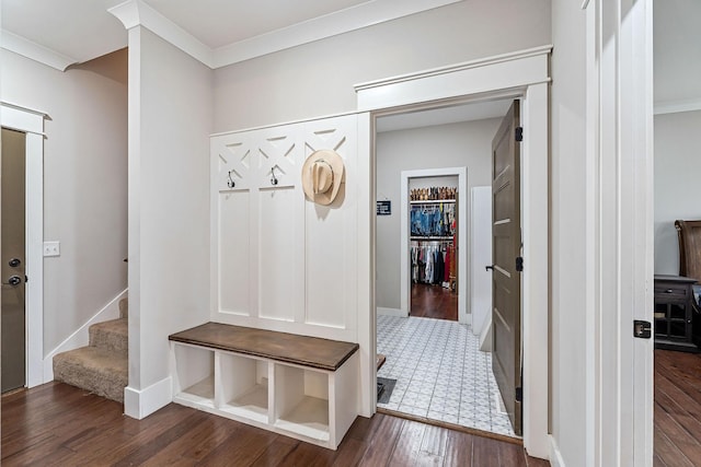 mudroom featuring dark wood-type flooring and ornamental molding