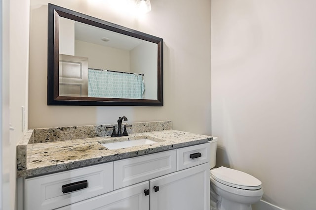 bathroom with vanity, toilet, and curtained shower