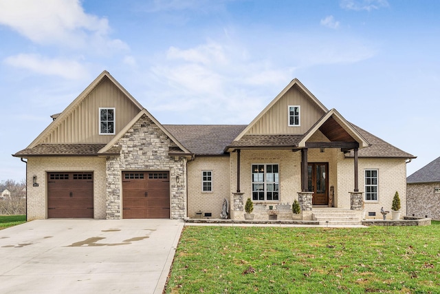 craftsman house with covered porch, a garage, and a front lawn