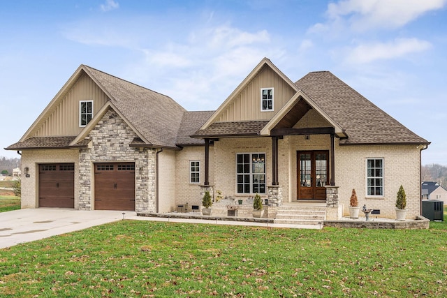 view of front facade featuring french doors, central AC unit, a front yard, a garage, and covered porch