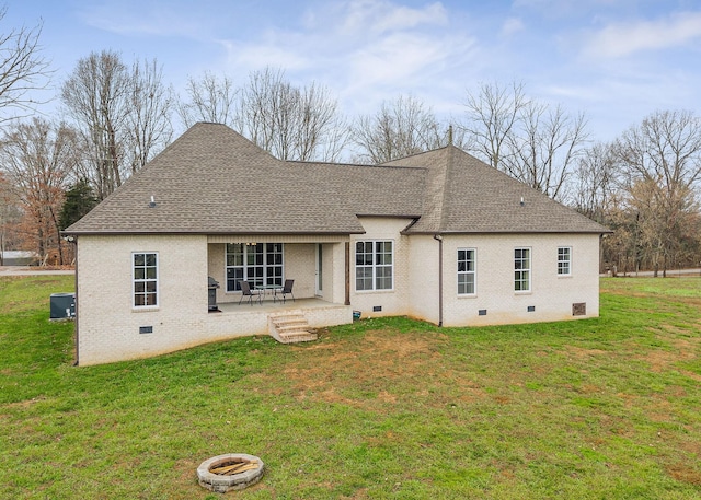 back of property with a yard, a patio, and central air condition unit