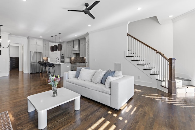 living room featuring sink, ceiling fan, ornamental molding, and dark hardwood / wood-style floors