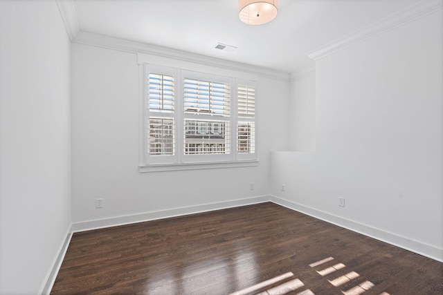 spare room with a healthy amount of sunlight, dark hardwood / wood-style floors, and ornamental molding