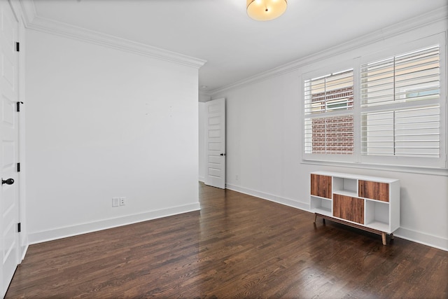 empty room featuring dark hardwood / wood-style floors and ornamental molding