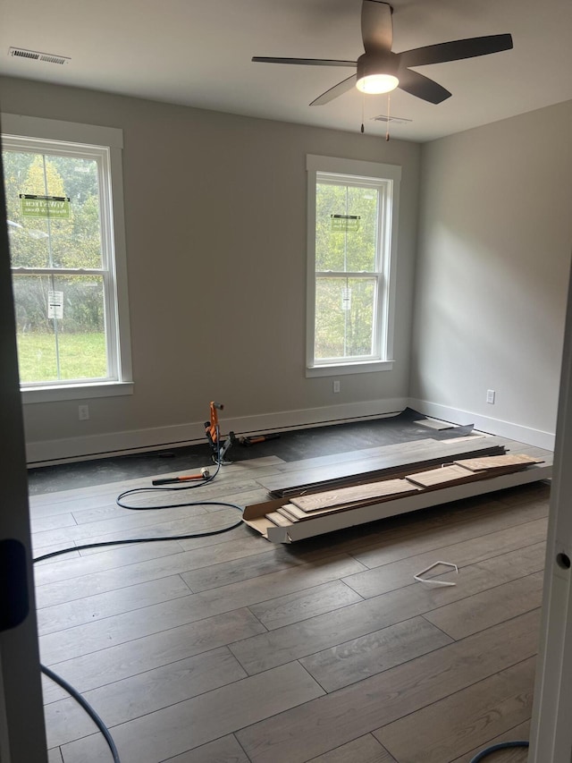 empty room featuring ceiling fan and light hardwood / wood-style flooring