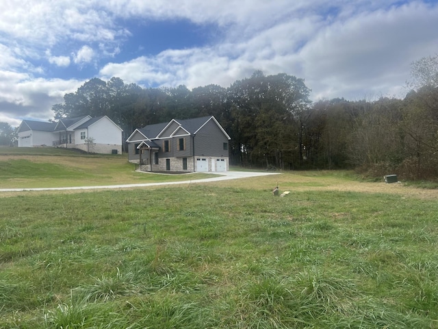 view of front of property featuring a garage and a front lawn