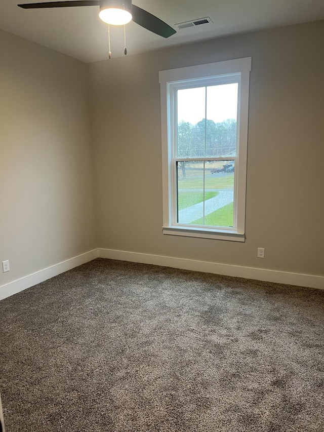 empty room with ceiling fan and carpet